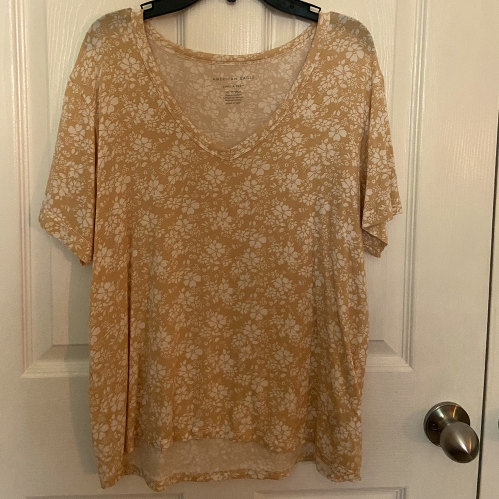 Beige shirt size XS with floral print, v-neck.